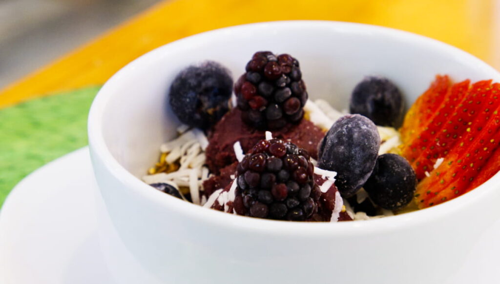 The acai bowl at Nopal Cafe features frozen blackberries, blueberries, and strawberries with shredded coconut and a frozen fruit medley.