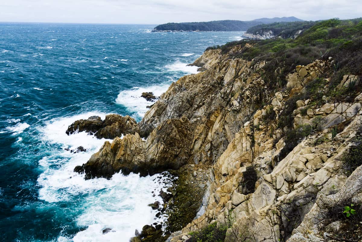 After you travel from Oaxaca to Huatulco, you'll be rewarded with these dramatic, rugged cliffs that drop into the Pacific Ocean as white caps flow into the jagged rocks below.
