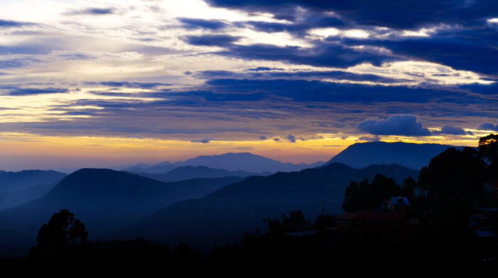 A sunset mountain view among the clouds in San Jose del Pacifico, which has cooler temperatures than Oaxaca City.