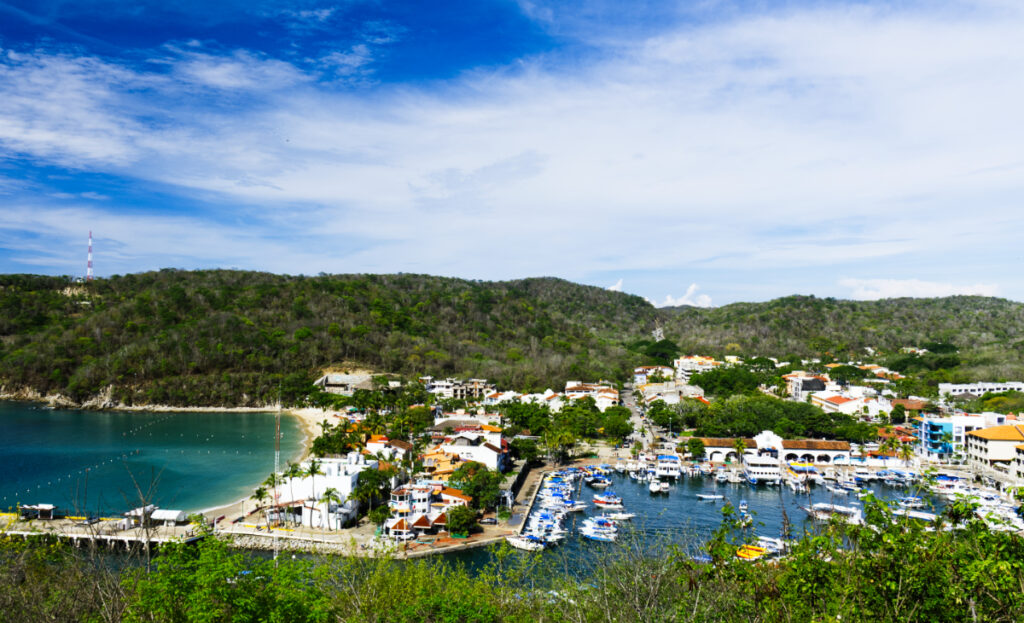 Your Oaxaca to Huatulco transportation will take you to Las Bahias de Huatulco. In the center of it all is Santa Cruz Bay. This overview shot of the marina is full of boats. Just past the buildings on the left is Santa Cruz Bay, one of the most popular beaches in Huatulco, Mexico.