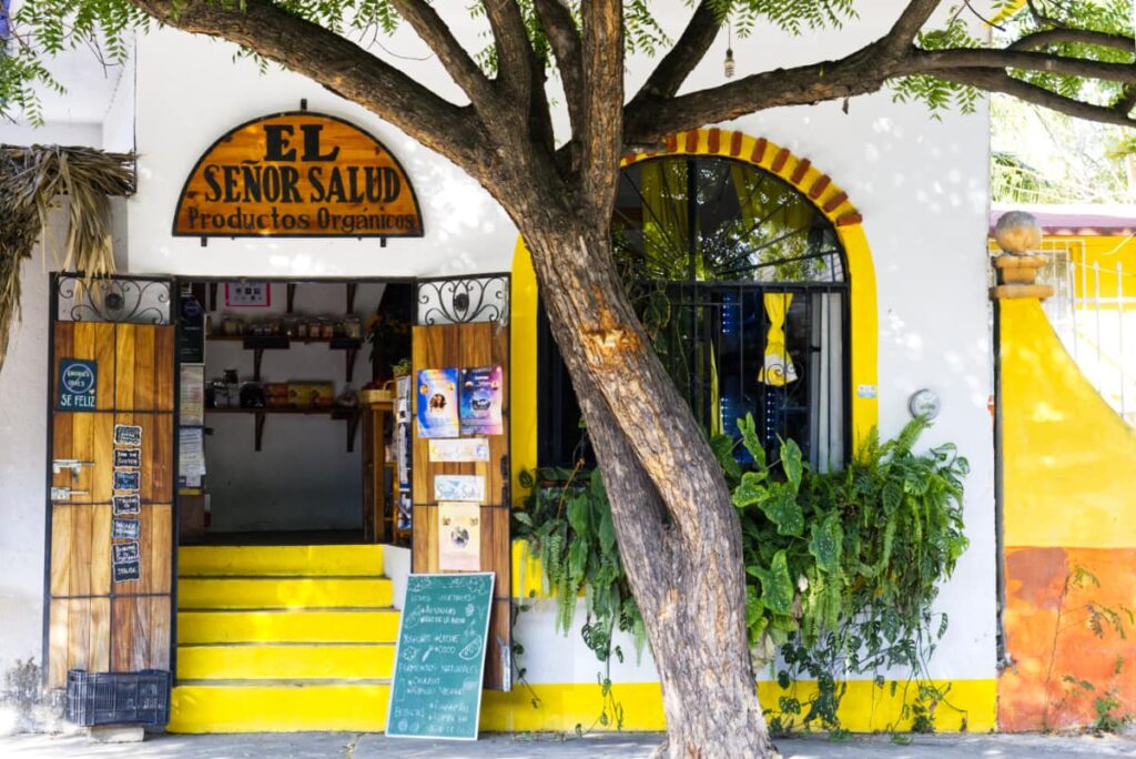 Bright yellow accents on the stairs and window frame welcome patrons to Senor Salud, a health food store in Puerto Escondido.