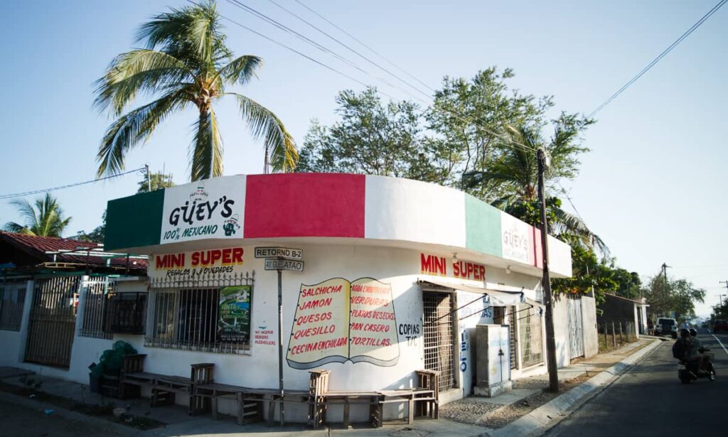 A small super market sits on a corner in Rinconada, one of the best Puerto Escondido neighborhoods. It's mostly white with hand painted letters and the colors of the Mexican flag, white, red, and green.