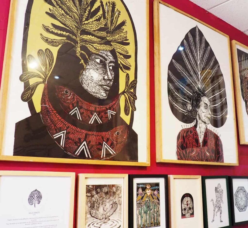 Framed graphic art prints hang on the walls of a graphic art studio, one of the best things to do in Oaxaca.