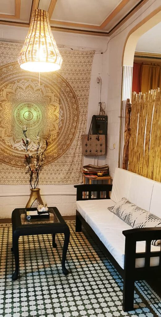 At Nativo Spa in Oaxaca, the waiting room features a black and white tiled floor with a white couch and gold accents.