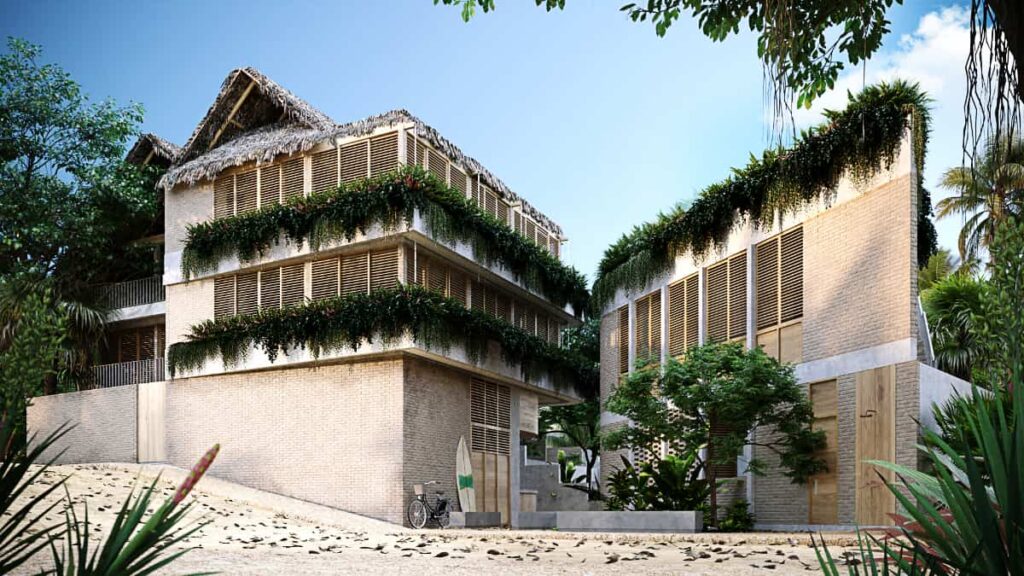 A 3D render of SobreLuna Coliving in La Punta features a multi level building with wrap-around windows and planters with green plants. A second, triangular shaped building has a similar design. Leaning against one wall is a bicycle and surfboard.