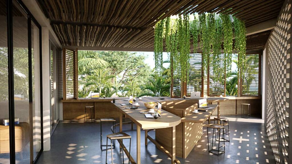 A 3D render of a coworking space at SobreLuna features several long tables to work including a wide open window area. A long fern-like plant grows through an opening in the ceiling.