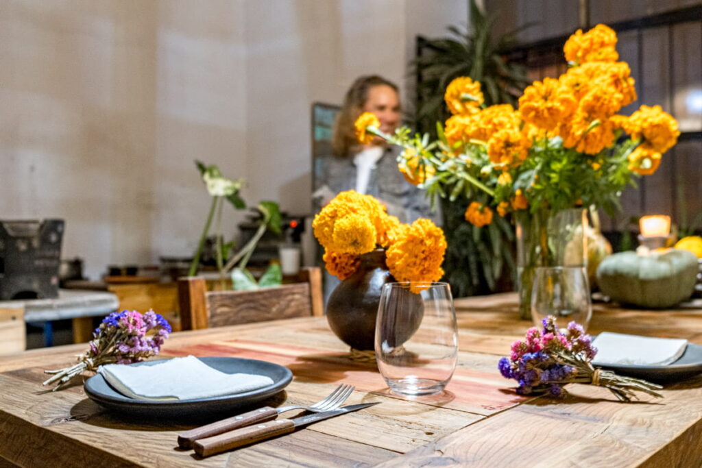 Orange marigold flowers decorate the large wooden table at Cataran restaurant in Oaxaca.