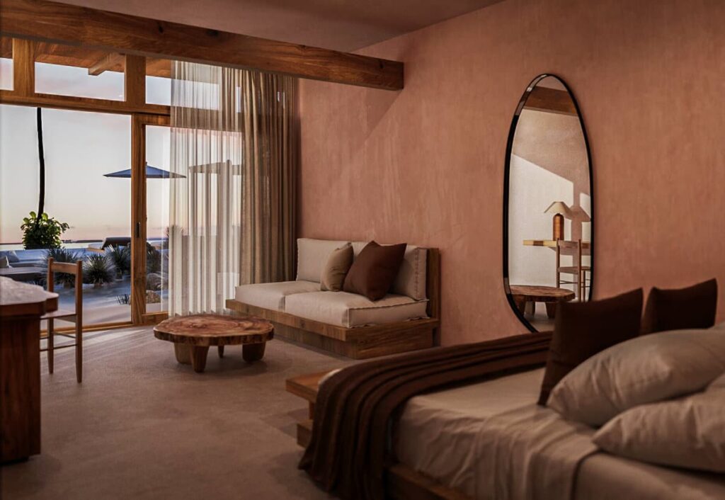 A view of bedroom at Xeno Hotel featuring a cozy bed, sofa, a wooden coffee table, a mirror and a private outdoor space.