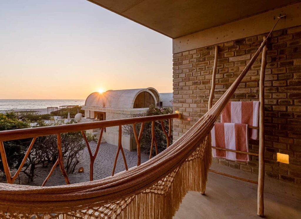 A view of the ocean and the sunset at Casa Sforza from the room's private outdoor space furnished with a hammock.